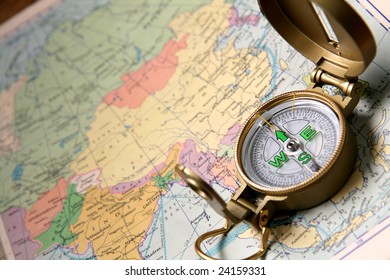 A compass on the world map of the atlas. - Shutterstock ID 24159331
