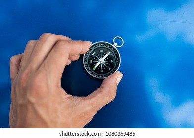 compass over blue background - Shutterstock ID 1080369485