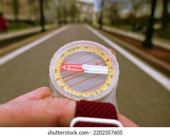 A Compass In A Person's Hand. Orient Yourself In The Current Situation (urban Conditions). Follow The Innner Compass, Intuition Concept, Public Sentiments