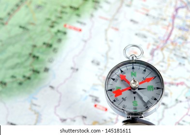 Compass photoed against the background of the map - Shutterstock ID 145181611