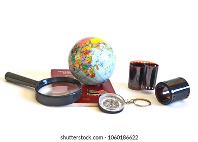 Compass, SIM Cards For Mobile Phone, Magnifier Glass, Globe Of Earth, Foreign Passport And Roll Of 35 Mm Full Frame Color Vintage Film Strip For Photo Camera On White Background