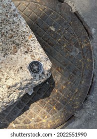 A Compass In A Steel Frame And With A Black Dial On The Background Of A Steel Hatch