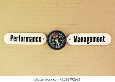 compass and stick with the word Performance Management. systematic approach within organizations to enhance employee effectiveness, align individual goals with company objectives, - Powered by Shutterstock