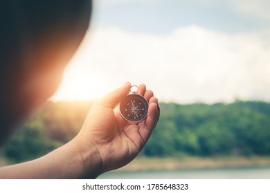 Compass of tourists on mountain at sunset sky.