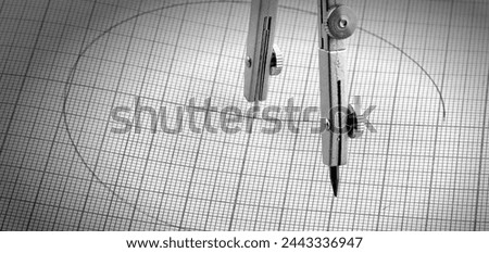 Compasses and a circle painted on graph paper