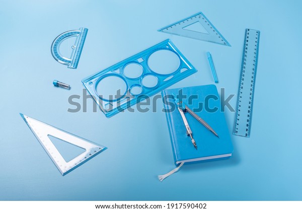 Compasses and rulers. Compass and
notepad. Compasses and rulers for sketching. Angle
view.