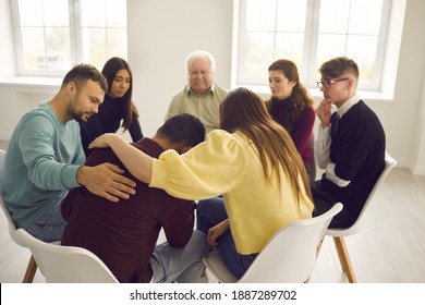 Compassion, help and dealing with problems in group therapy session at rehab center. Diverse young and senior people sitting in circle, supporting and comforting crying, stressed, desperate man - Powered by Shutterstock