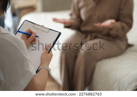 compassionate therapist provides a safe and nurturing space for her patient to share her innermost thoughts and feelings. psychologist listens attentively and takes notes to understand the patient's