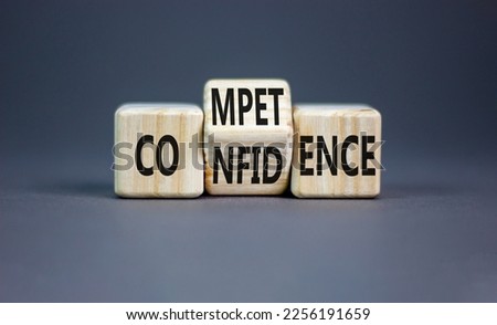 Competence and confidence symbol. Concept word Competence Confidence on wooden cubes. Beautiful grey table grey background. Business and competence and confidence concept. Copy space.