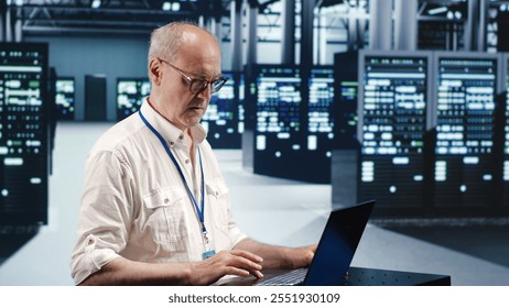 Competent inspector expertly managing data while navigating in industrial server room. Experienced system administrator ensuring optimal cybersecurity protection, optimizing systems