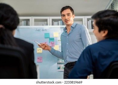 Competent office workers from various nationalities are debating, discussing and brainstorming in the meeting room. A group of employees is collaborating to achieve their business objectives. - Shutterstock ID 2233819669