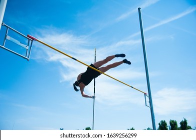 Competition Pole Vault Jumper Female On Blue Sky Background