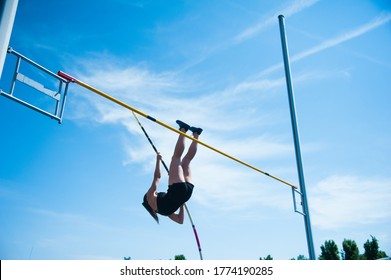 Competition Pole Vault Jumper Female On Blue Sky Background