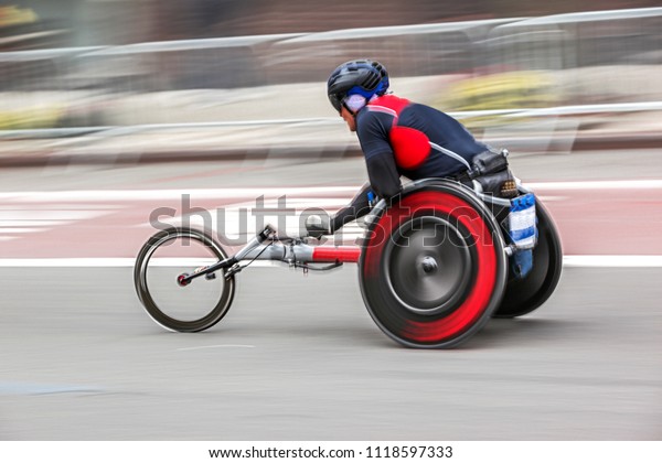 competition\
sports wheelchair racing in motion\
blur