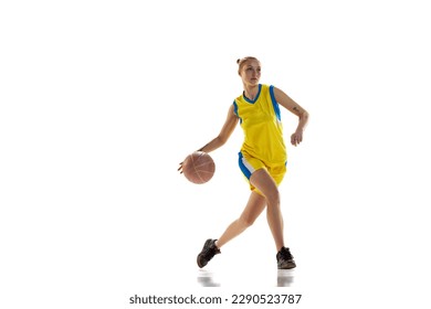 Competition. Young sportive girl, basketball player in uniform training, playing against white studio background. Concept of professional sport, hobby, healthy lifestyle, action and motion - Powered by Shutterstock