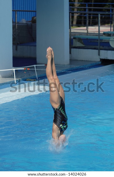 Competitions on jumps in water. A beautiful jump of\
the harmonous girl