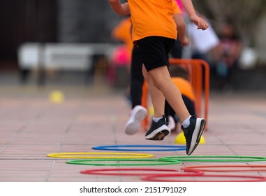 Competitive active game, children jump over obstacles - Shutterstock ID 2151791029