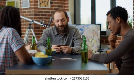 Competitive People Playing Board Games With Cards At Table, Enjoying Tactics With Leisure Activity. Positive Group Of Friends Having Fun Together With Strategy Card Competition. Close Up.