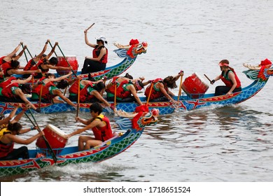 A competitive racing on Keelung River, where the women athletes pull vigorously on the oars to the pace of the drumbeats by the team leaders, in the traditional Dragon Boat Festival in Taipei, Taiwan