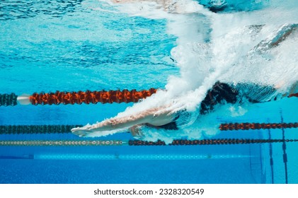 Competitive swimmer diving into pool