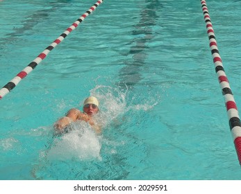 A competitive swimmer in a high school swim meet - Powered by Shutterstock