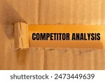 Competitor analysis message written on ripped paper with color background. Conceptual competitor analysis symbol. Copy space.