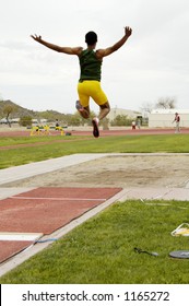 A Competitor In The Men's Long Jump Event During A College Track Meet.