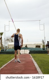 A Competitor In The Men's Pole Vault Event During A College Track Meet.