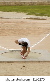 A Competitor In The Men's Shot Put Event During A College Track Meet.