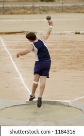 A Competitor In The Men's Shot Put Event During A College Track Meet.