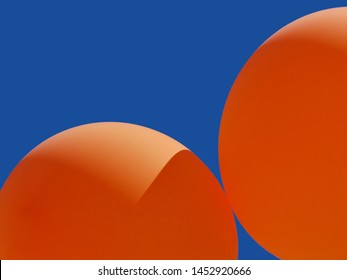 Complementary Colors - Two Orange Balloons Against A Blue Sky