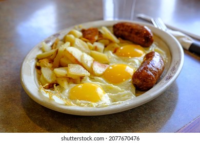 Complete American Diner Breakfast Three Sunny Side Up Fried Eggs Sausage And Home Fries