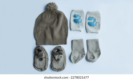 Complete brown baby fashion accessories from knitted hat, socks, knee pad socks, and shoes isolated on white background. - Shutterstock ID 2278021677