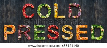 complete collection of alphabet letters made from healthy green fruit and vegetables on rustic distressed texture, overhead flat lay