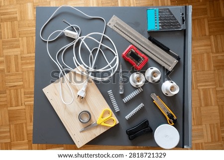 Complete DIY ceiling light installation kit arranged on a worktable