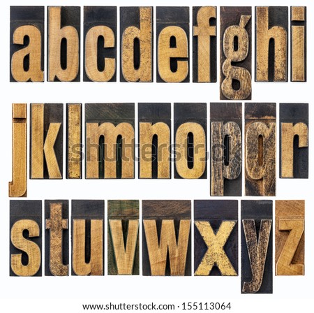 complete English lowercase alphabet - a collage of 26 isolated antique wood letterpress printing blocks, scratched and stained by inks