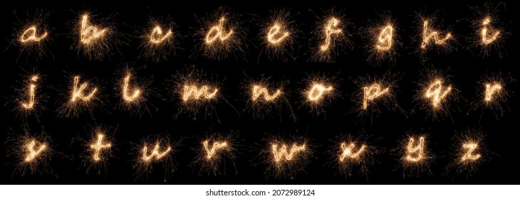 complete full golden bright sparkler alphabet font letter set collection A to Z isolated on dark black background. silvester new year birthday and celebration design pattern