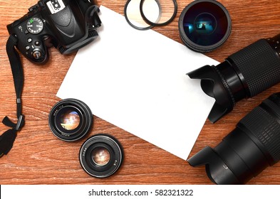 Complete kit for modern digital SLR camera and blank sheet of paper for copyspace. The concept for learning photography. Cover for photo exhibitions, online photo lessons and tutorials