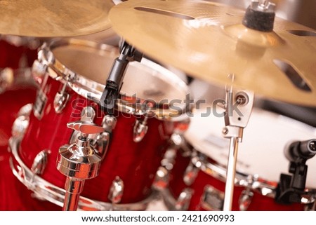 Complete set of cymbal instruments with complete red drums in studio music concept.