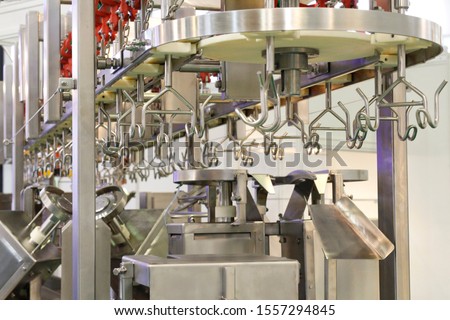 Complete set of the line of slaughter of a bird. Automated line for cutting and portioning poultry carcasses. Equipment in the carcass cutting shop. Production.