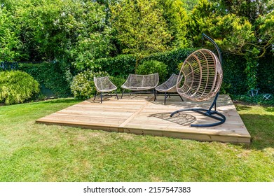 A completed decking construction in a garden in Market Harborough, UK in early summer - Shutterstock ID 2157547383