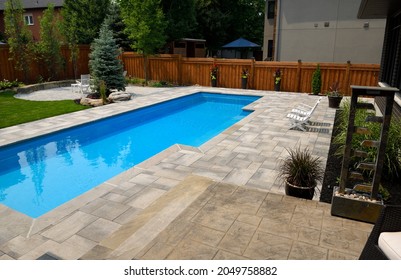 Completed Landscaping Around New Swimming Lap Pool In Back Yard With Paver Patios Gardens And Lawn Barrie, Ontario, Canada - July 18, 2021