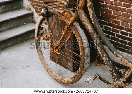 Completely rusty old bicycle on a street corner. Top down, close up view, no people