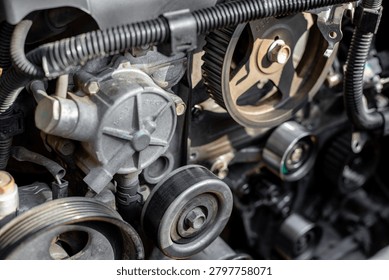 Complex arrangement of idler rollers and timing belts in an engine during service. belt system layout, workshop maintenance, technical inspection.