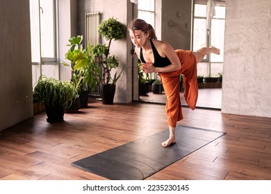 Complex exercises for body flexibility. A slender woman does sports for health.