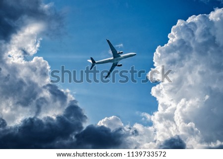 Complex flight conditions - plane flies through storm clouds, rainy weather, storm front.  Concept of air safety. Empty place for copy space.