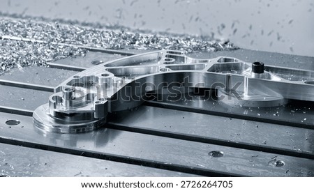 Complex metal work on machine table, made on modern programmable CNC multifunctional metalworking machine, industrial concept background
