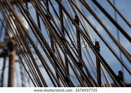 Complex network of rigging and ratlines on a vintage tall ship. Concept of connection, strength, and teamwork. Elegance and vintage charm of classic clipper navigating.