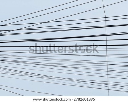 a complex and overlapping tangle of electrical or communication cables