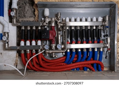 Complex residential heating manifold system with valves, gauges, and piping network.